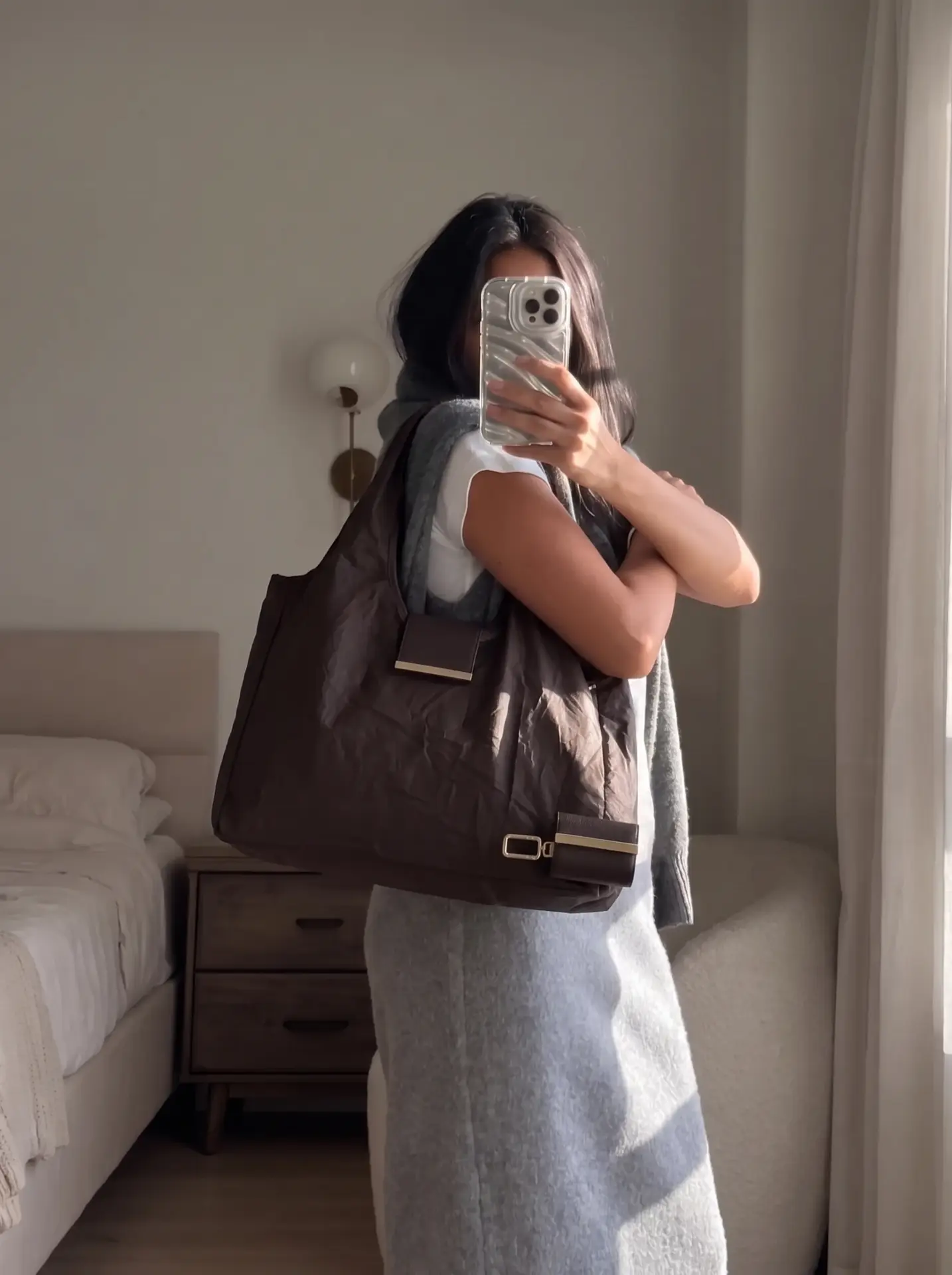 Model in a grey knit dress carrying the espresso Cliqué Tote over her shoulder